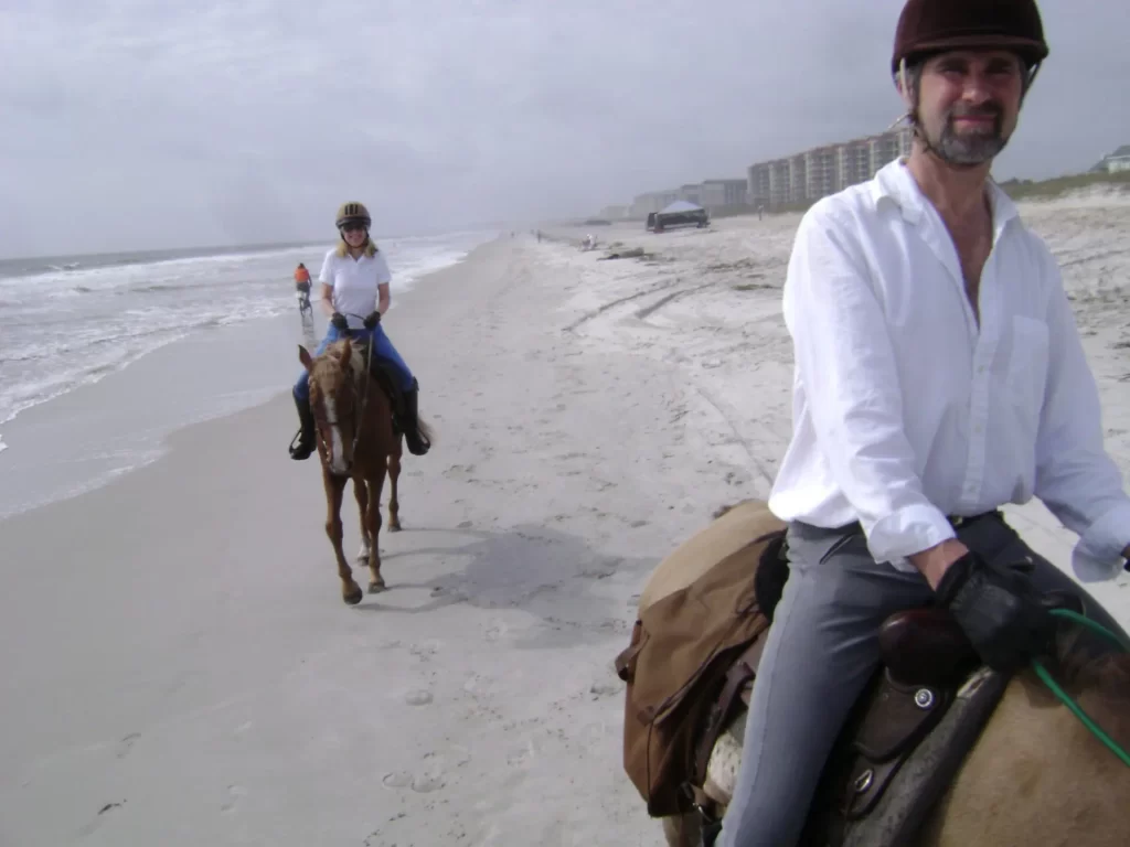 Couple on a beach horse riding in FL