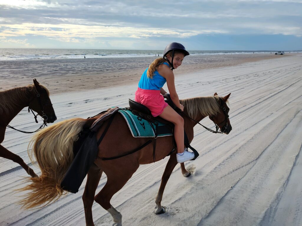 Girl on a horseback beach ride in FL